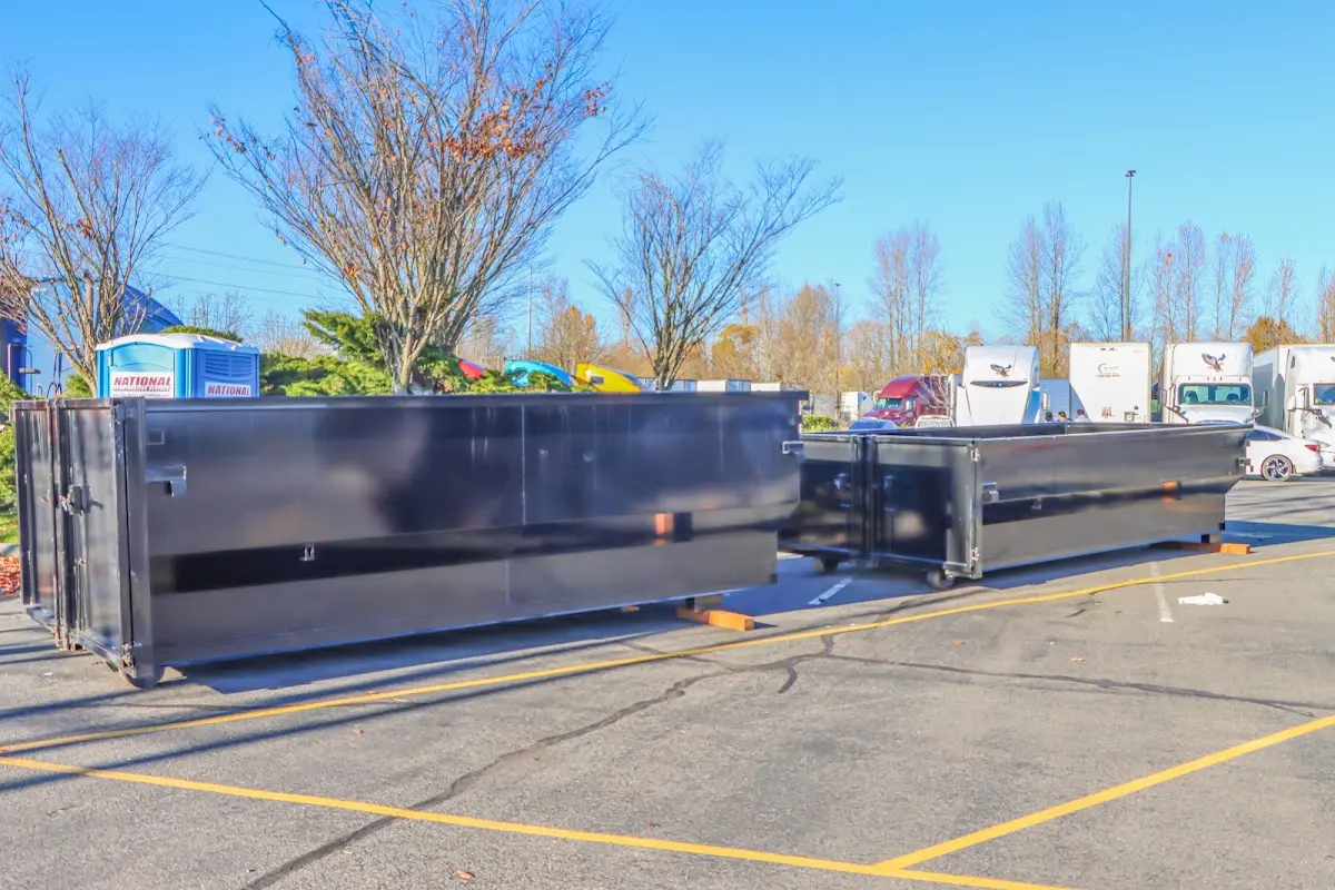 Professional dumpster rental service with roll-off container on residential driveway in Tuttle